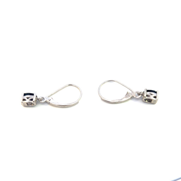 One estate pair of sterling silver drop earrings with 2 oval-shaped faceted dark blue sapphires and leverback closures