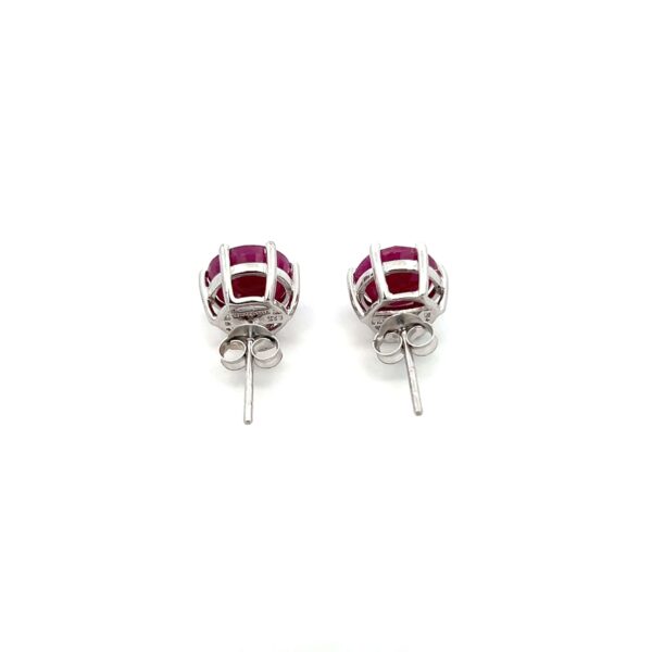 One estate pair of sterling silver stud earrings with 2 round-faceted rubies measuring 8mm each in six-prong settings