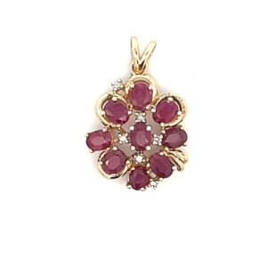 One estate 14 karat yellow gold cluster pendant set with 9 oval faceted rubies and 6 round brilliant diamond accents