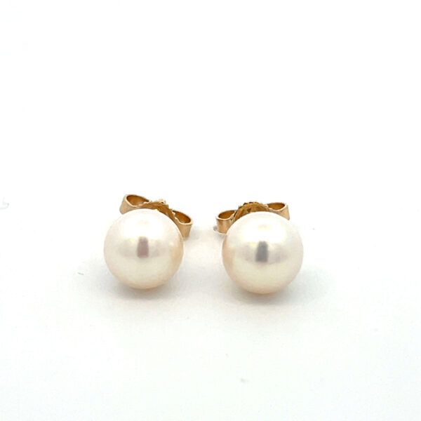 Estate pair of 14 karat yellow gold stud earrings with solitaire 7.5mm pearls.