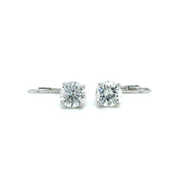 An estate pair of 14 karat white gold drop earrings with 2 round brilliant diamonds weighing 1.50 carats total weight