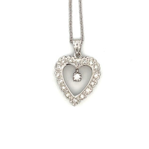An estate retro 14 karat white gold open-style heart pendant necklace featuring 17 round diamonds on an 18" chain