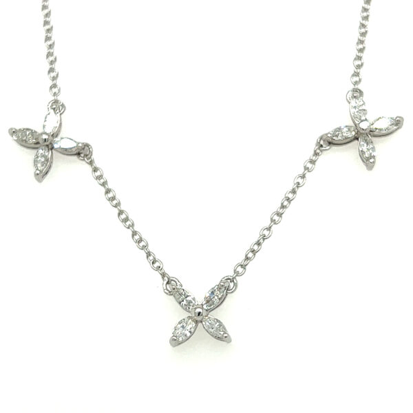 An estate 14 karat white gold station necklace with 12 marquise diamonds set in 3 floral clusters
