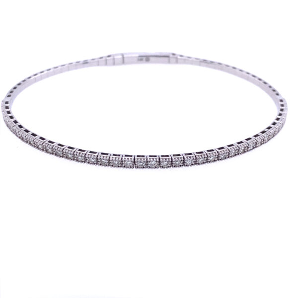 A 14 karat white gold bangle bracelet with 0.54 carat of round diamonds