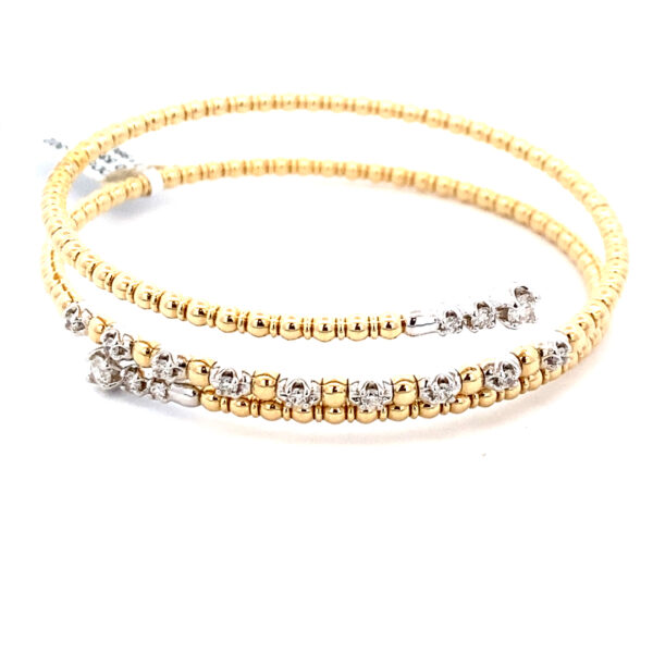 A two-tone gold bead-style wrap bracelet with diamond end caps and set in part of the middle row