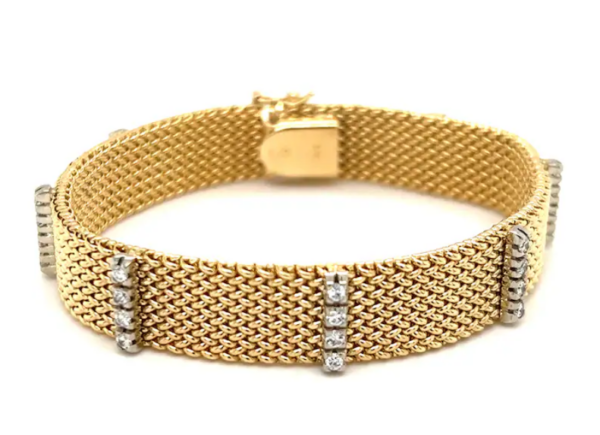 An estate 14 karat yellow gold mesh bracelet with 7 stations of 4 sparkling diamonds.