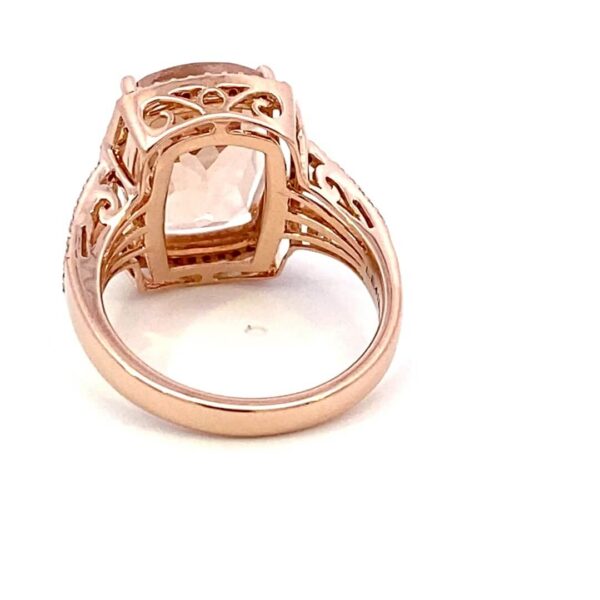 One 14 karat rose gold fashion ring by Lali with a center elongated cushion-cut morganite weighing 6.24 carats with 0.37 carats of round brilliant diamonds set in the halo and the double split-shank band