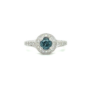 An estate 14 karat white gold ring with a round blue zircon and diamonds in the halo and shoulders of the ring