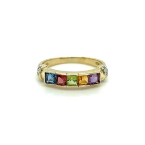 An estate 14 karat yellow gold fashion band featuring amethyst, pink tourmaline, peridot, blue topaz, and citrine with diamond accents