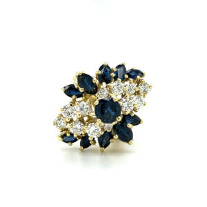An estate vintage 18 karat yellow gold waterfall design ring with blue sapphires and diamonds