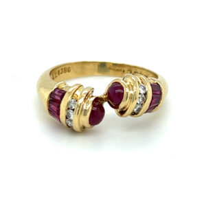 An estate 18 karat yellow gold bypass band with rubies and diamonds