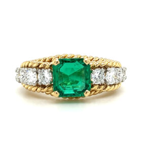 An estate vintage 18 karat two-tone gold fashion ring with a center square-cut emerald, diamonds in the band, and rope texture accents