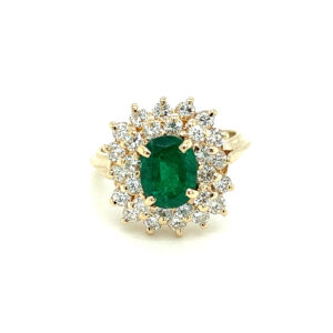 One estate vintage 14 karat yellow gold ring with a center oval emerald and a double diamond halo