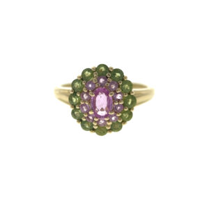 One estate 14 karat yellow gold multi-halo ring with a center oval pink sapphire, a halo of round pink sapphires, and an outer halo of round peridots