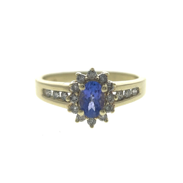 One estate 10 karat yellow gold ring with an oval-faceted tanzanite and diamonds in the halo and the band