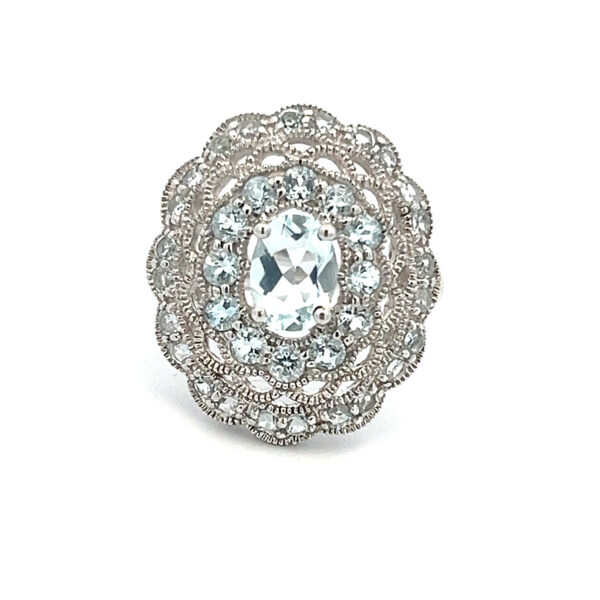 An estate sterling silver ring with a cluster of blue topazes in a multi-halo design
