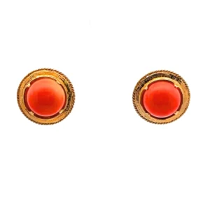 One pair of 14 karat yellow gold salmon pink round cabochon coral stud earrings with yellow gold halo frames.