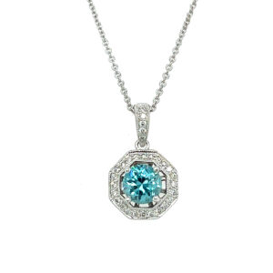 One estate 14 karat white gold drop pendant necklace with a round blue zircon and 29 round diamonds in the halo and in the bail