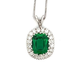 An estate 14 karat white gold pendant necklace with an elongated cushion emerald and an oval white sapphire halo