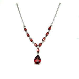 An estate silver drop necklace featuring faceted garnet stones