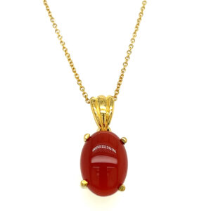 An estate vermeil necklace featuring an oval cabochon carnelian drop pendant on an 18" long chain
