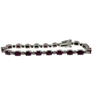 One estate sterling silver line bracelet with 19 oval-shaped faceted dark rubies with silver spacer links