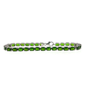 One estate sterling silver line bracelet with 29 oval-shaped faceted chrome diopside gemstones in four-prong settings with a lobster claw clasp