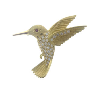 An estate 18 karat yellow gold hummingbird brooch set with a round ruby eye and 0.60 carats of round diamonds