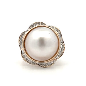One estate 14 karat yellow gold ring with a 15.2mm cream colored mabe pearl and a floral-inspired scalloped diamond halo