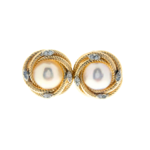 An estate pair of 14 karat yellow gold lover's knot stud earrings featuring mabe pearls and diamond accents