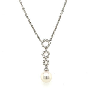 An estate Y-design necklace featuring a drop with a 7.5mm pearl and 0.25 carats of diamond accents