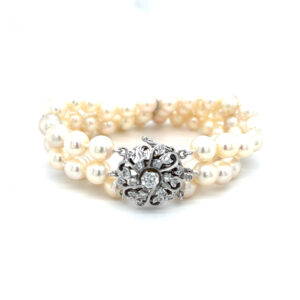 One estate triple-strand pearl bracelet with a white gold clasp and 0.55 carats of round accent diamonds