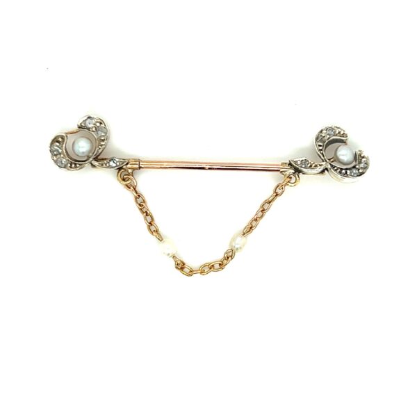 One estate Edwardian pin made from sterling silver and 9 karat yellow gold with seed pearls and rose-cut diamonds