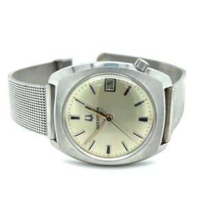 An estate vintage watch made from stainless steel with a creamy silver dial three-hand movement, and mesh bracelet.