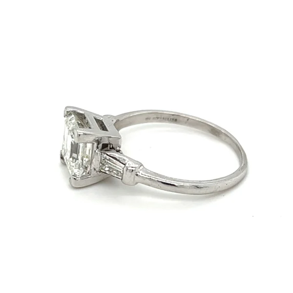 One estate plantinum and 14 karat white gold art deco-inspired engagement ring a center asscher-cut diamond weighing 2.13 carats flanked by 2 tapered baguette diamonds