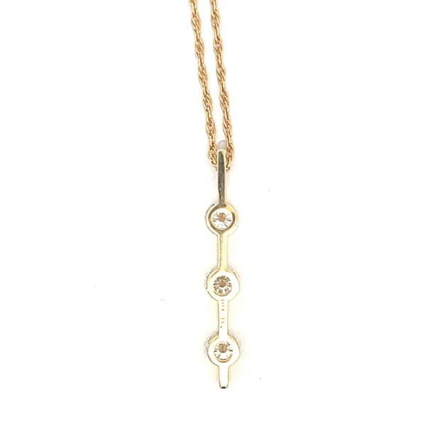 One (1) 14 karat yellow gold bar design pendant set with three (3) round brilliant diamonds approximately 1.00 total carat weight with matching I/J color and SI/I1 clarity. The pendant is suspended on one (1) 14 karat yellow gold 19" rope chain.