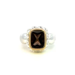 One estate sterling silver fashion ring with an elongated cushion-shaped faceted smoky quartz in an 18 karat yellow gold bezel setting