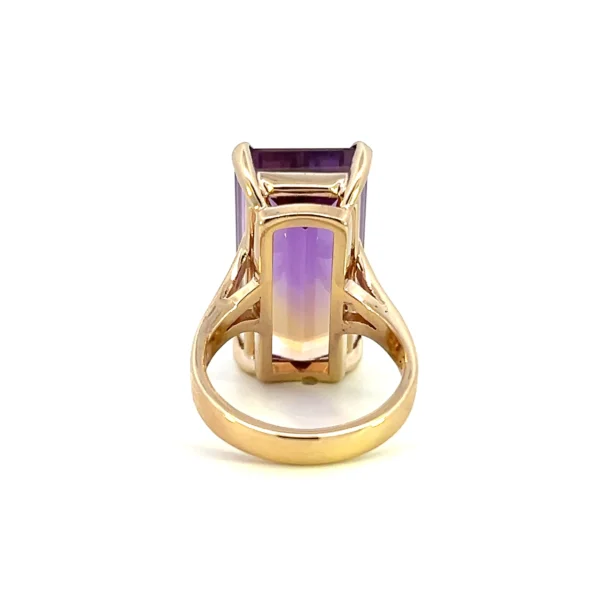 One estate 14 karat yellow gold solitaire gemstone ring with an emerald-cut ametrine weighing 18.93 carats in a four-prong setting