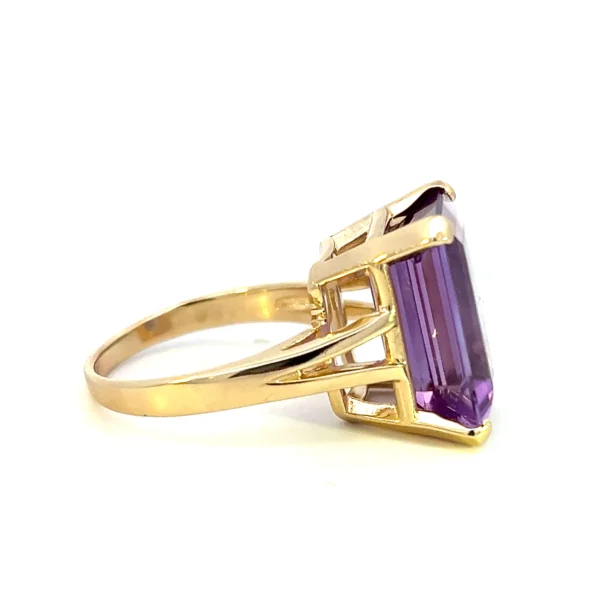 One estate 14 karat yellow gold solitaire gemstone ring with an emerald-cut amethyst weighing 8.88 carats in a four-prong setting