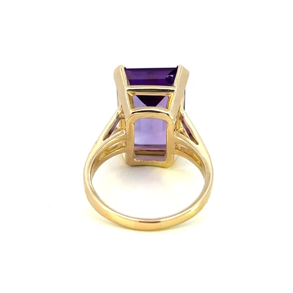 One estate 14 karat yellow gold solitaire gemstone ring with an emerald-cut amethyst weighing 8.88 carats in a four-prong setting