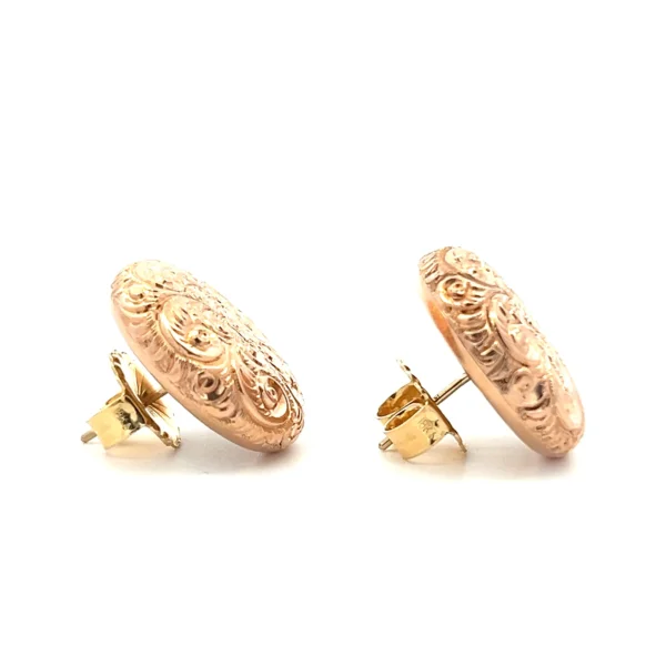 One pair of estate 14 karat rose gold button stud earrings from the 1930s featuring hand-engraved flower designs.