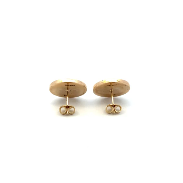 One pair of estate 14 karat yellow gold round disc stud earrings with hand-engraved heraldic snake designs with friction posts and backs. Each earring measures 15mm round. The earrings are vintage from the 1950s.