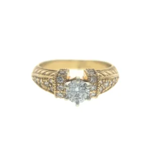 One 14 karat yellow gold vintage-inspired engagement ring with a center round brilliant diamond weighing 0.70 carats in a white gold six-prong setting with 20 round brilliant accent diamonds in the band with etched designs