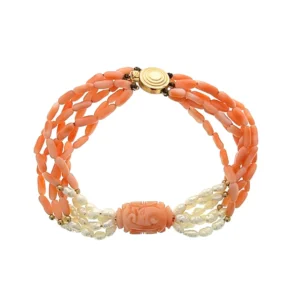 One estate orange coral bead and freshwater pearl bracelet with a 14 karat yellow gold clasp