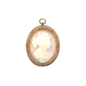 The Estate Vintage Pink Cameo and Seed Pearl Pendant/Pin is crafted from 10 karat yellow gold, there is a 35x37 oval shaped pink conch shell cameo with a woman's profile and a halo of 53 seed pearls. the item can be worn has a pin or as a pendant.
