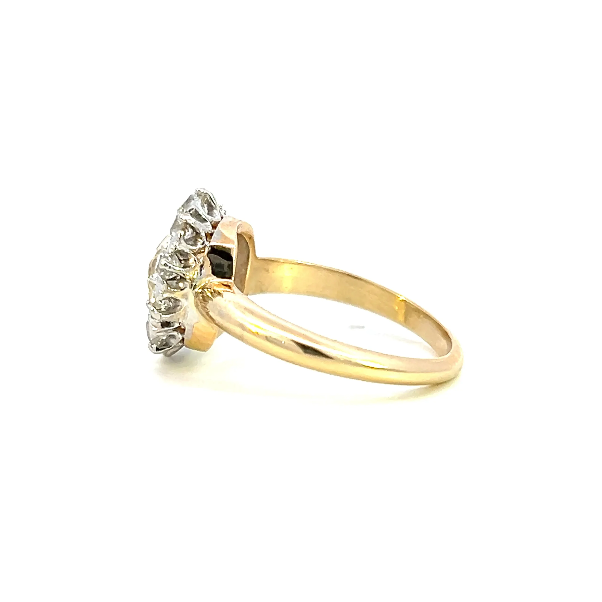 One estate 14 karat yellow gold and platinum ring set with a center old mine-cut diamond weighing 1.51 carats with M color and SI1 clarity and 10 old mine-cut diamonds weighing 0.50 total carat weight set in a halo. The ring is from the Edwardian era.