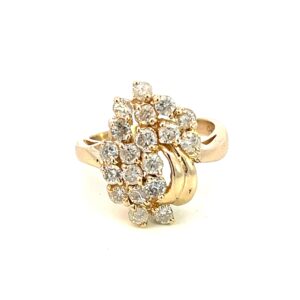 One 14 karat yellow gold diamond cluster ring from the 1980s containing 19 round brilliant diamonds in an asymmetrical cluster design.
