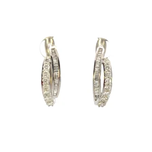 One pair of estate 10 karat white gold double hoop diamond earrings. Each huggie hoop has a strand set with round brilliant diamonds and one strand set with baguette diamonds for a total of 1.30 carats.