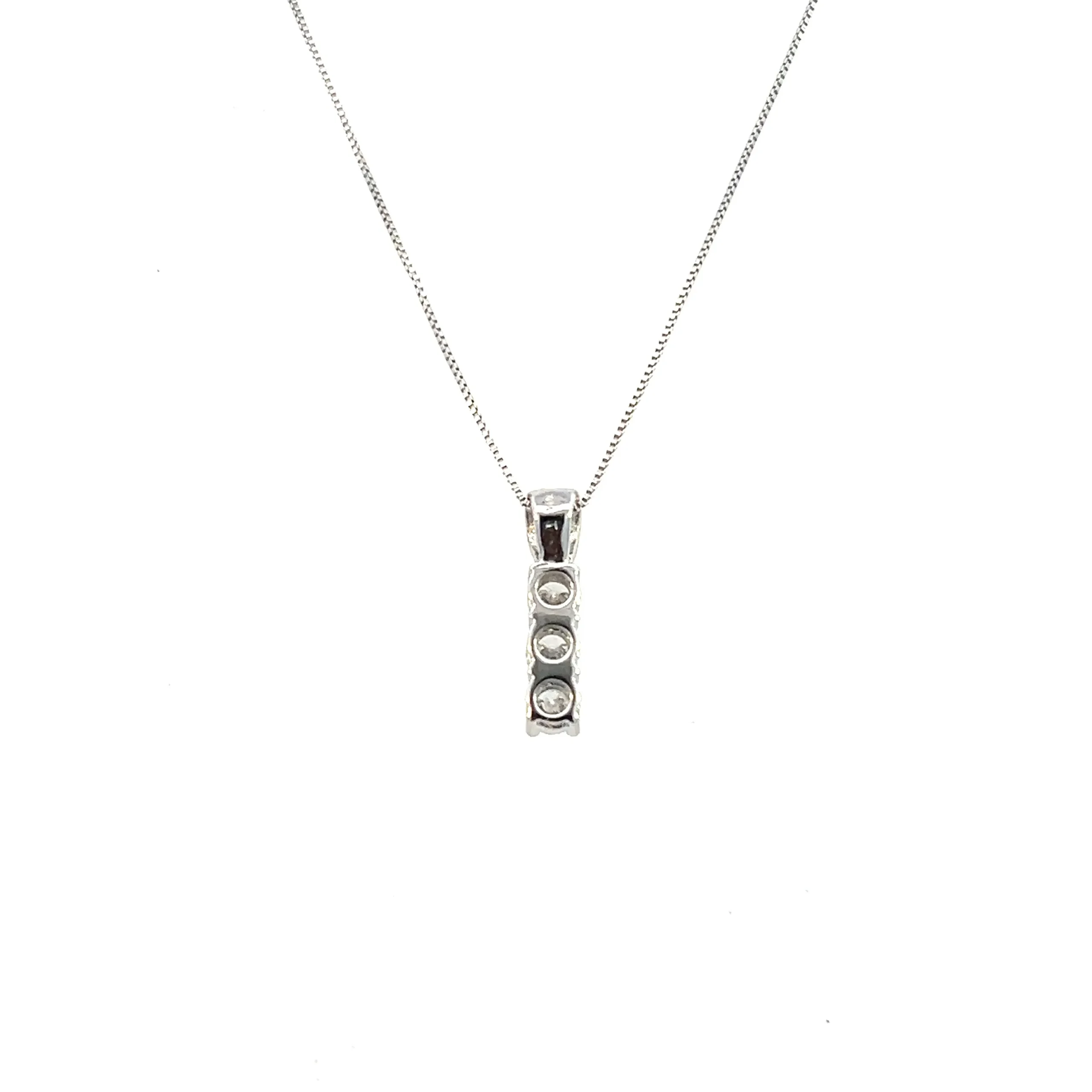 One estate three-stone diamond drop necklace crafted from 14 karat white gold containing a rectangle-shaped drop pendant set with 3 round brilliant diamonds weighing 0.47 carat total weight. The pendant is suspended from an 18" white gold box link chain with a spring ring clasp.