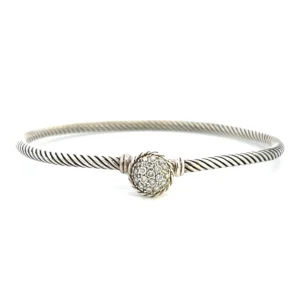 One estate David Yurman Diamond Bracelet containing a round cluster of round diamonds weighing 0.18 carat total weight in pave settings. The round area where the diamonds are set also functions as the clasp of the bracelet. the length of the bracelet is a twisted cable style.
